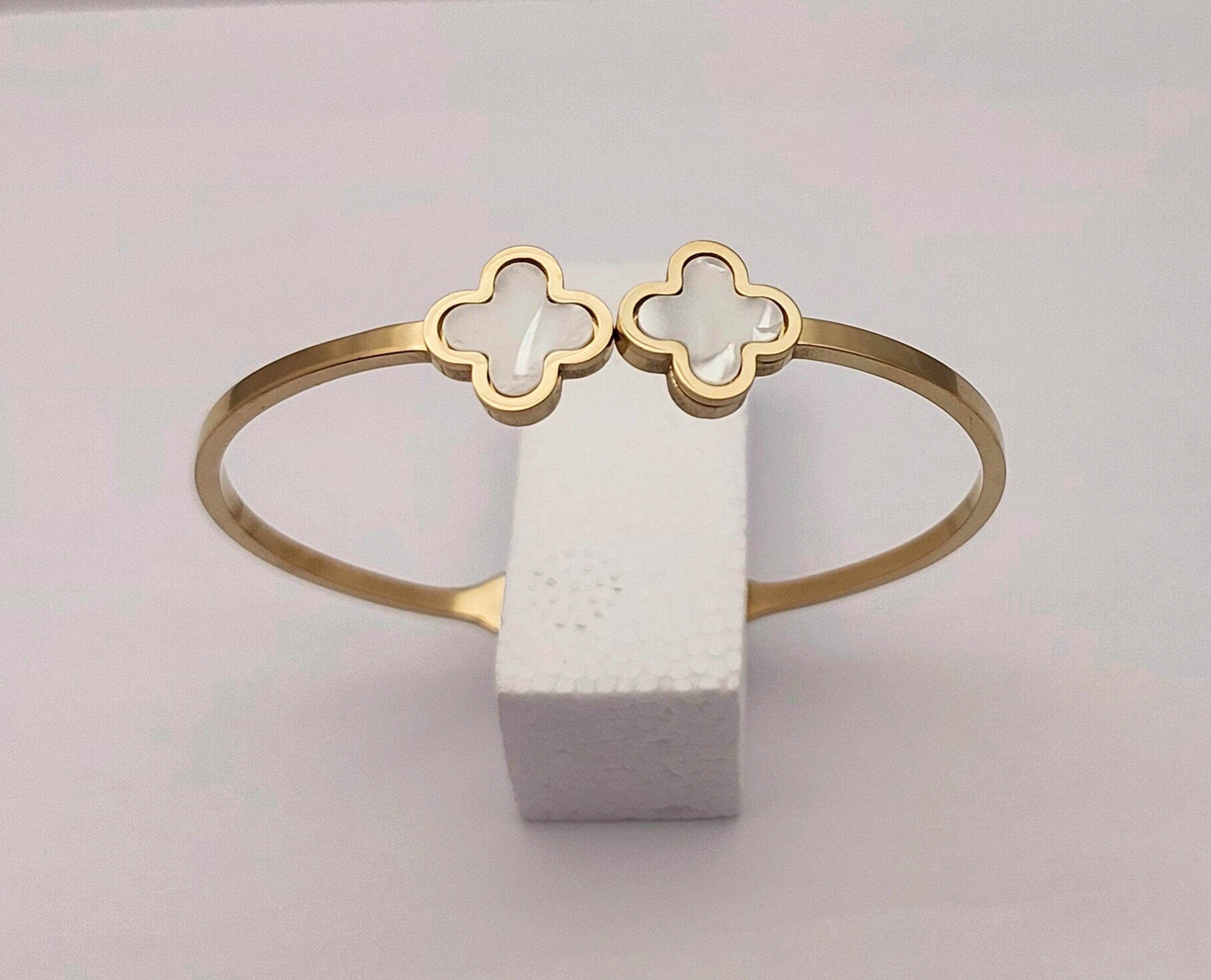 Gold toned clover hand cuff bracelet