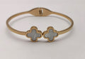 Gold toned clover hand cuff bracelet