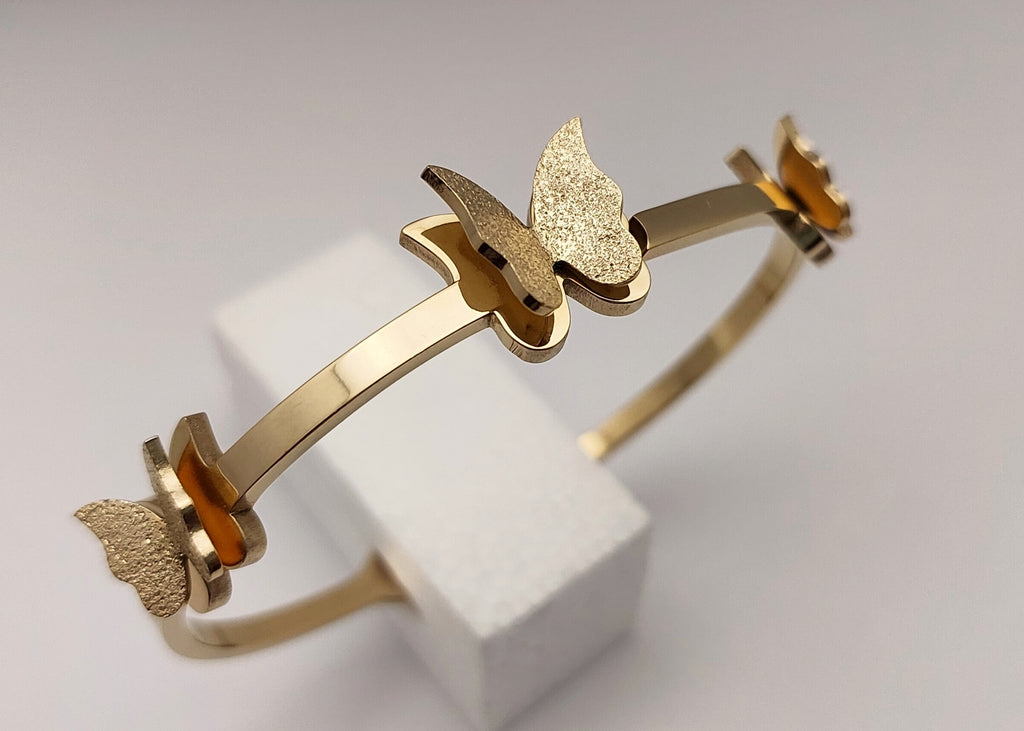 Gold toned Butterfly Charm handcuff bracelet