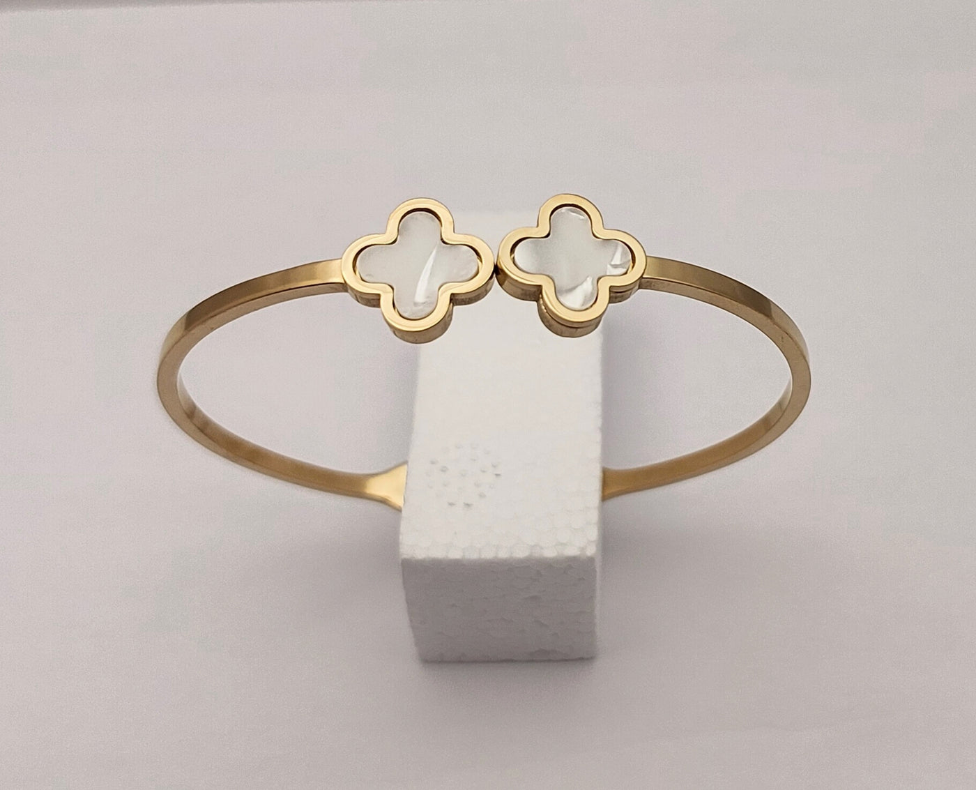 Gold toned clover hand cuff bracelet